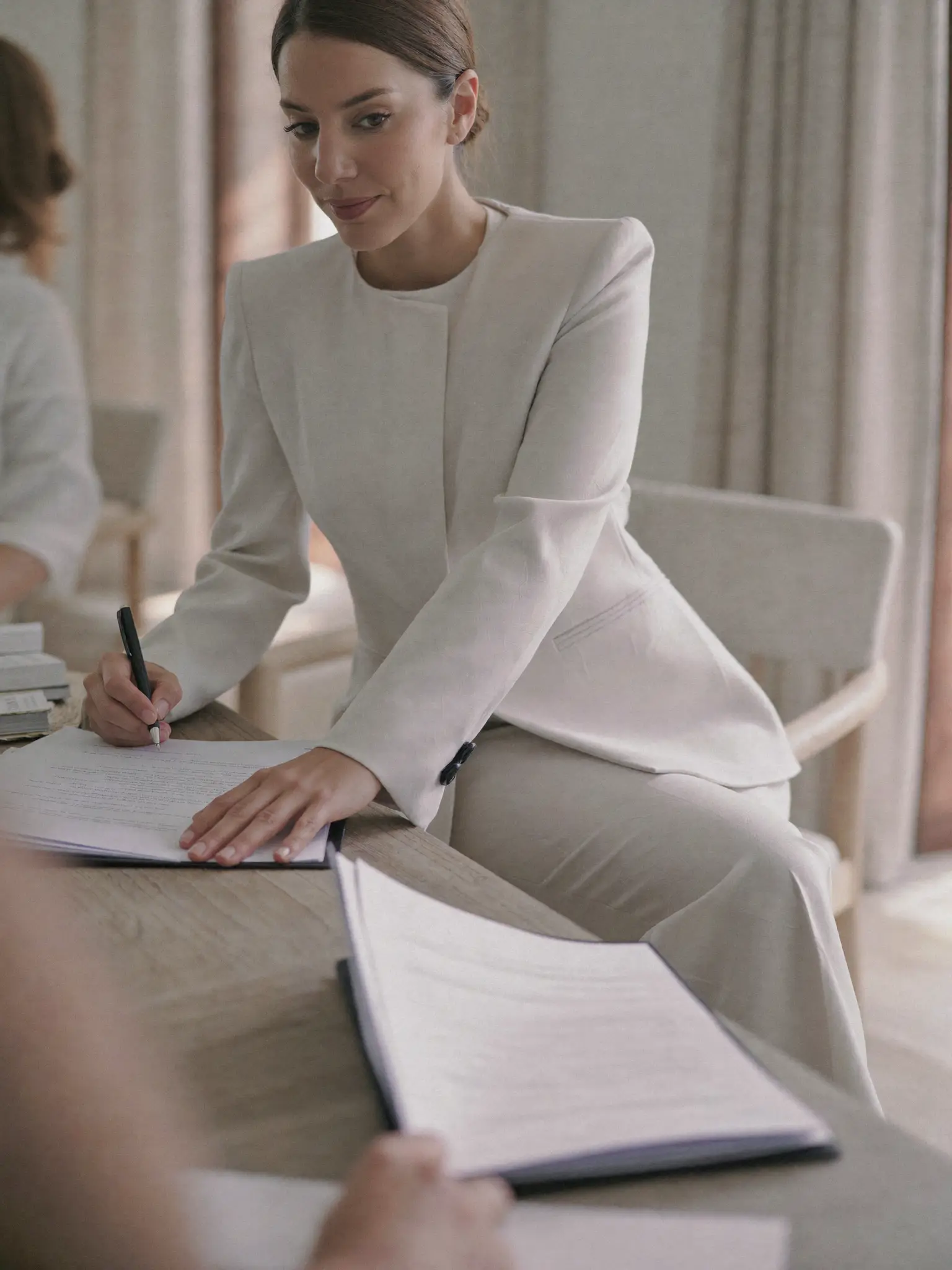 A hand signing a legal document.